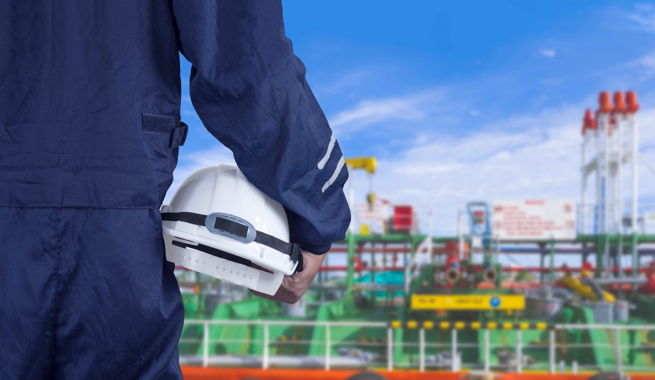 shipyard engineer-hand-holding-white-safety-helme
